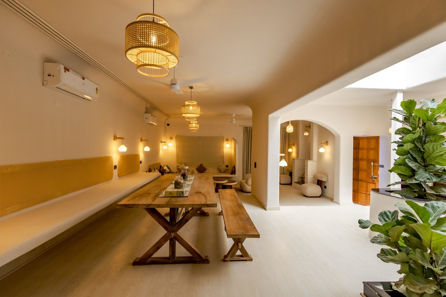 Warm naturally-lit living and dining space with timber detailing in a 5,300 sq ft villa in Gurgaon