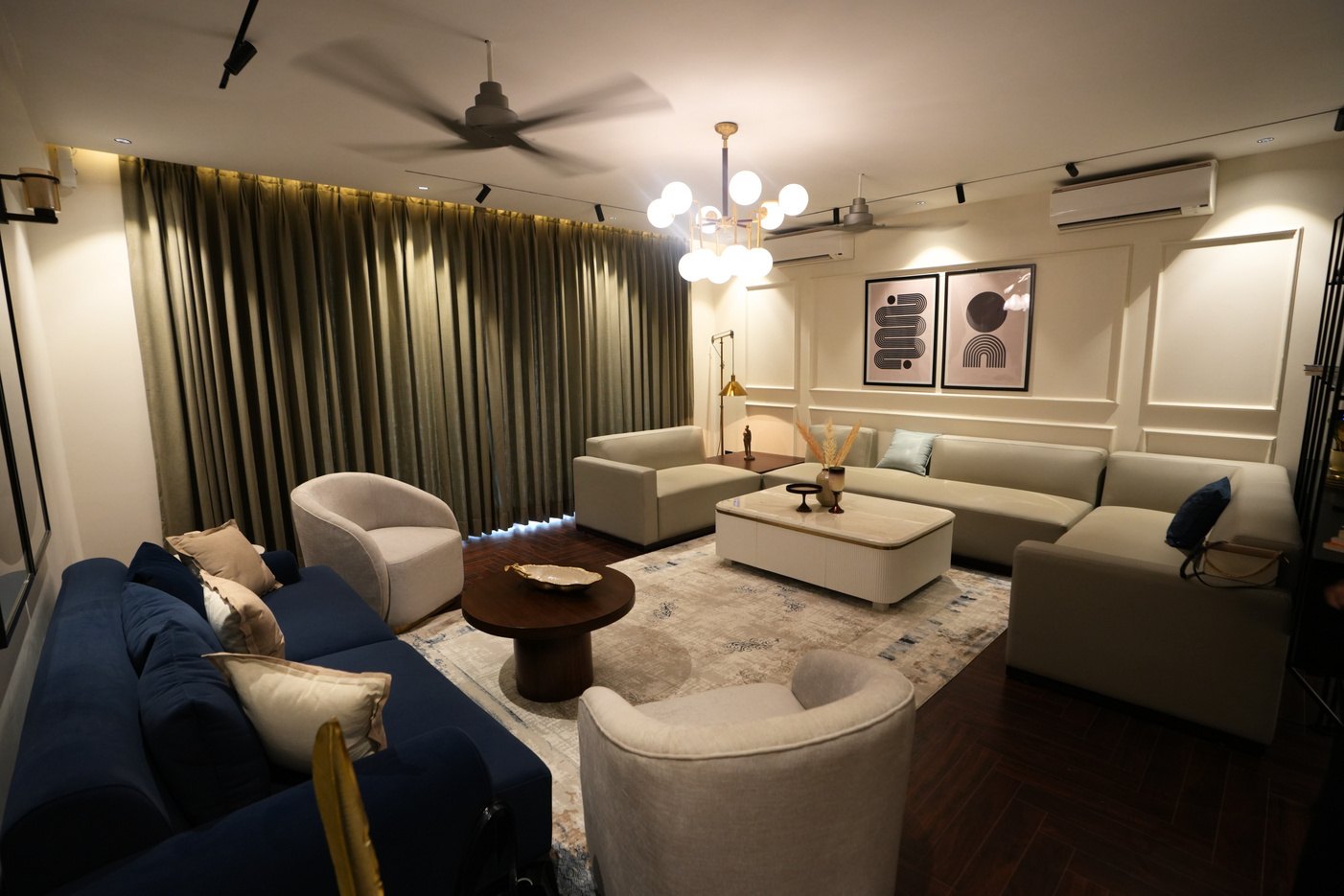 Elegant residential living room with layered lighting and custom furniture in Delhi NCR